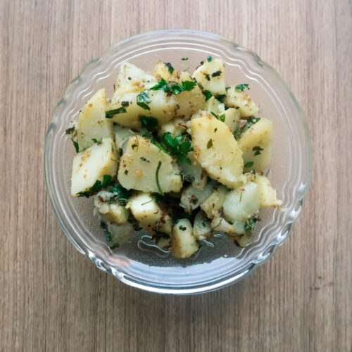 Dry aloo sabzi recipe served in a bowl on wooden table
