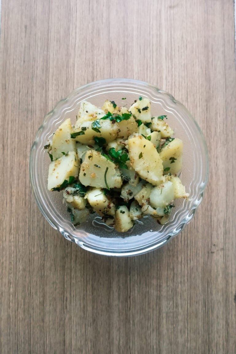 Dry aloo sabzi recipe served in a bowl on wooden table