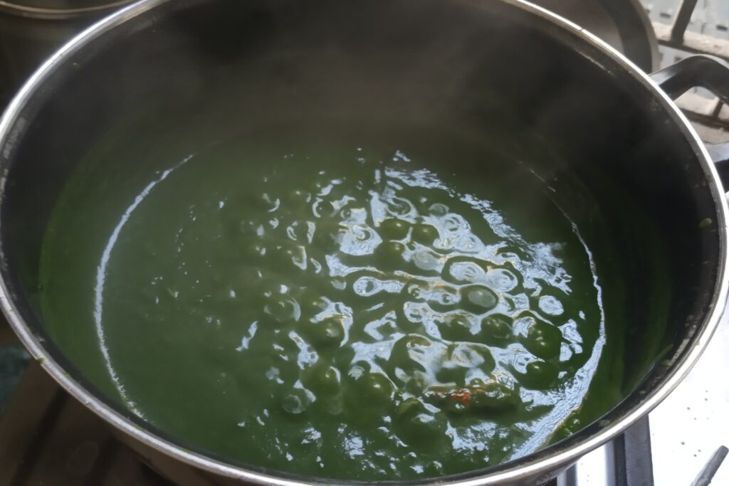 Simmering palak paneer in a kadai