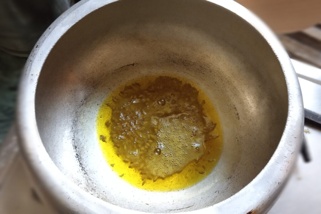 Heat oil with cumin seeds