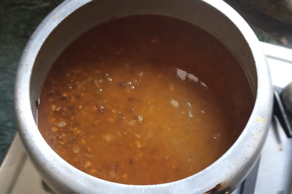 Whole urad dal simmering in a cooker