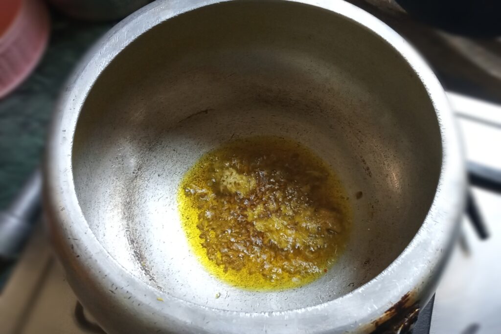 Cumin seeds and ginger paste are sizzling
