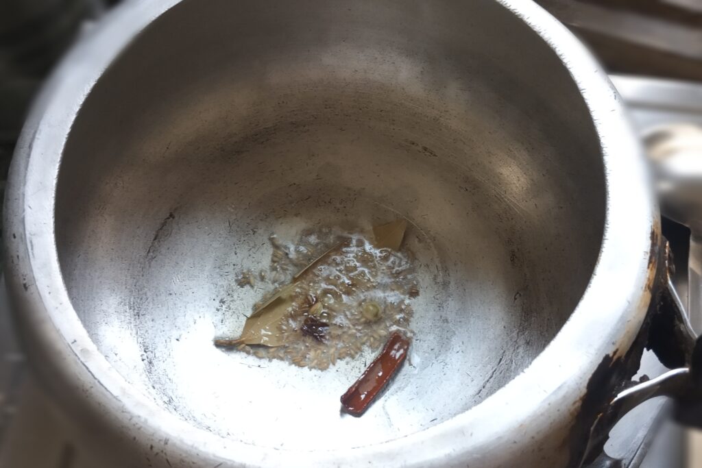 Tempering spices in ghee for cumin rice