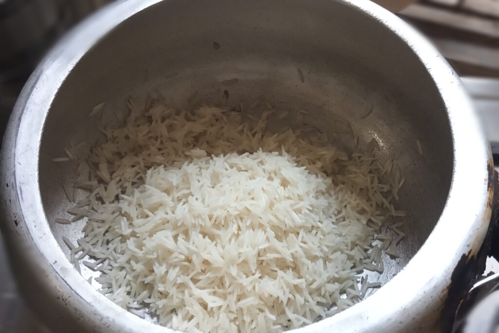 Soaked basmati rice in the tempering spices