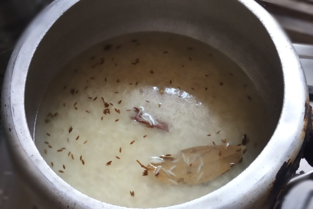 Adding water and salt in basmati rice