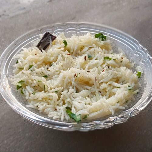 Jeera rice recipe in a bowl with basmati rice and cumin seeds