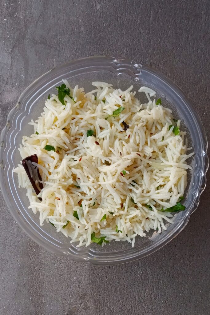 Hot and delicious jeera rice recipe served with herbs