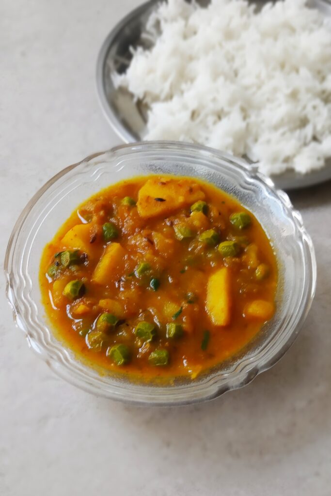 hot aloo matar recipe served in a bowl with rice