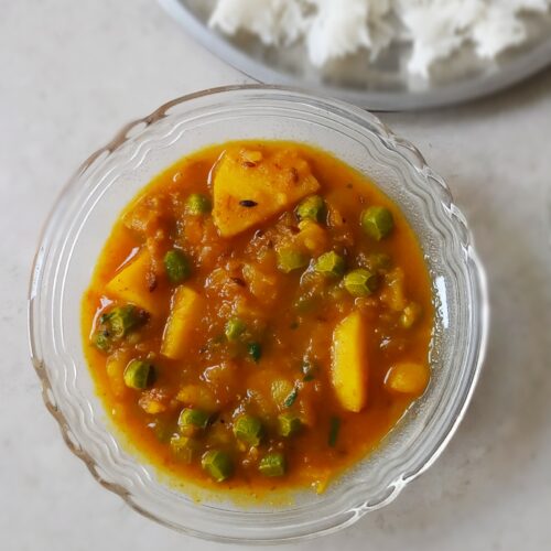 homemade aloo matar recipe served in a bowl with steamed rice