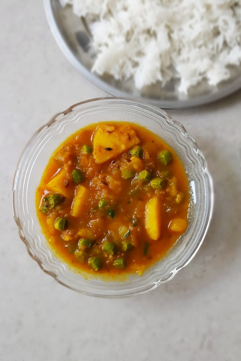 homemade aloo matar recipe served in a bowl with steamed rice