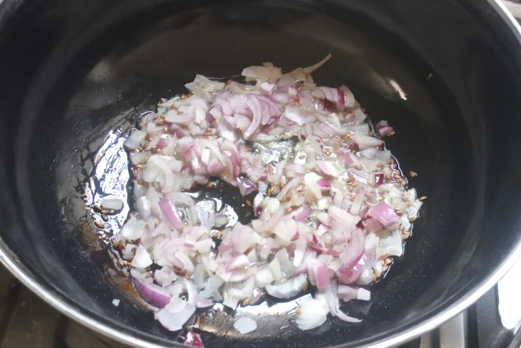 sauteing chopped onions with cumin seeds