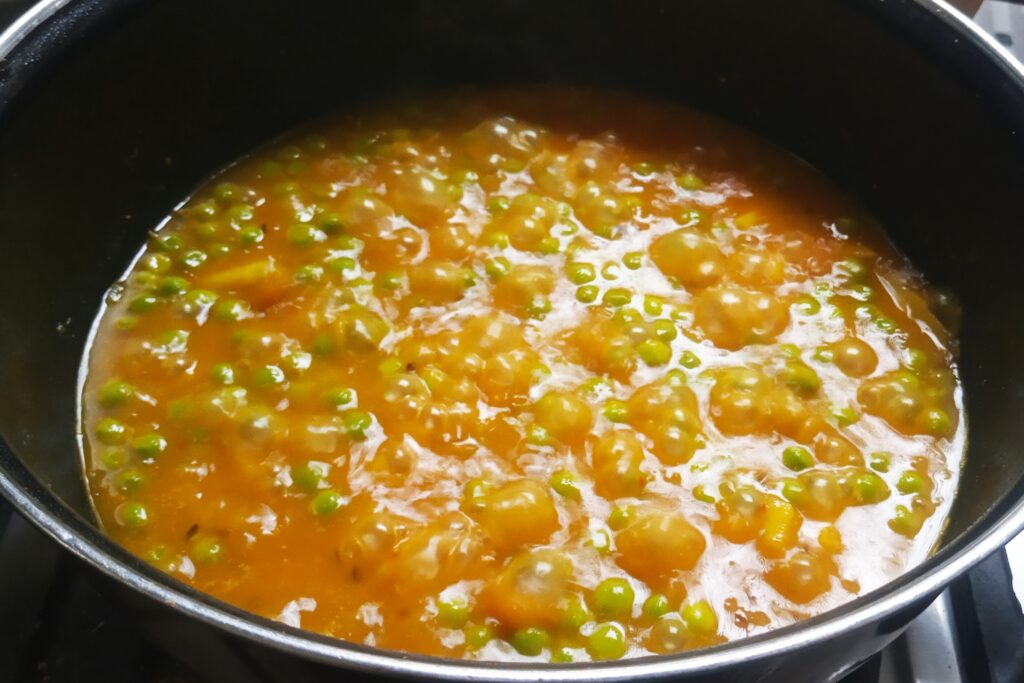 simmering aloo matar recipe until potatoes are soft