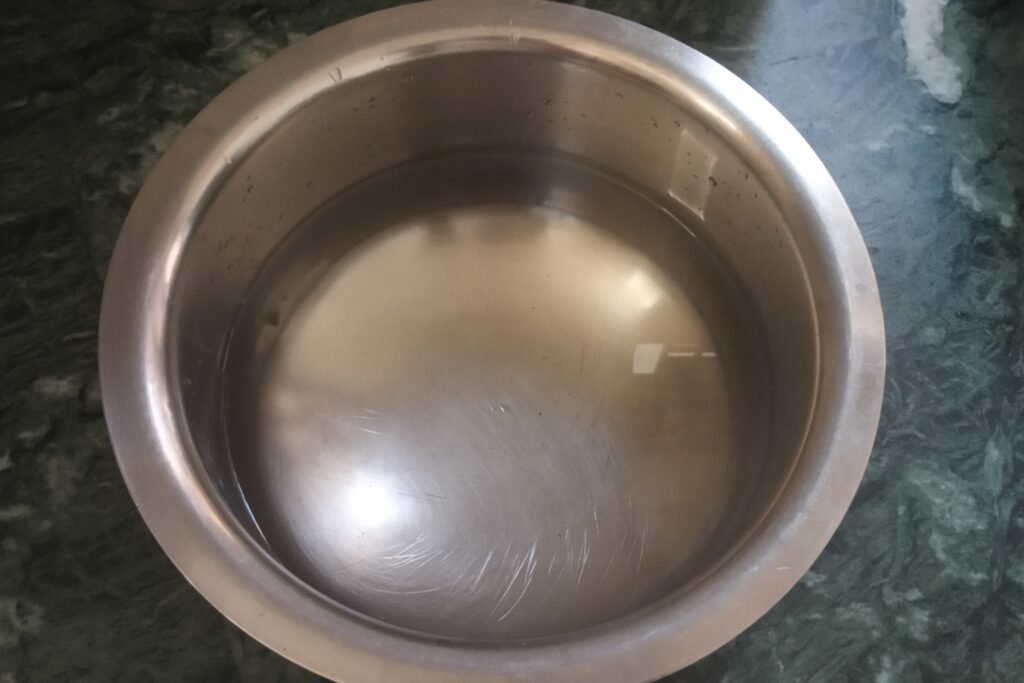 adding water in a mixing bowl for jal jeera