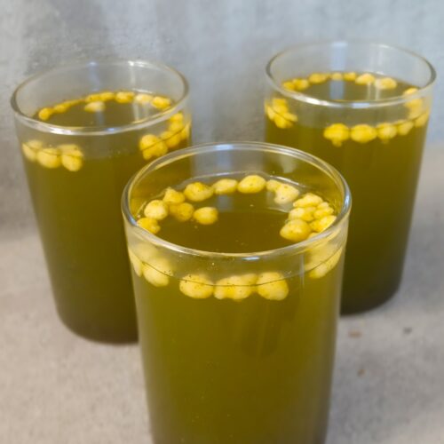 jal jeera recipe served in a glass with a garnish of boondi