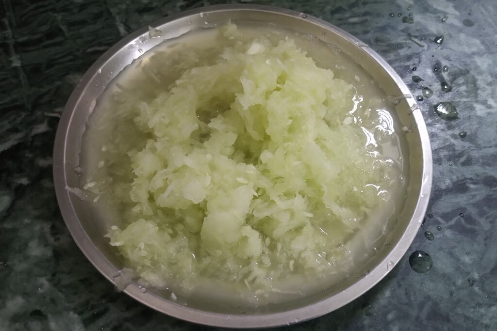 grating fresh cucumber for raita