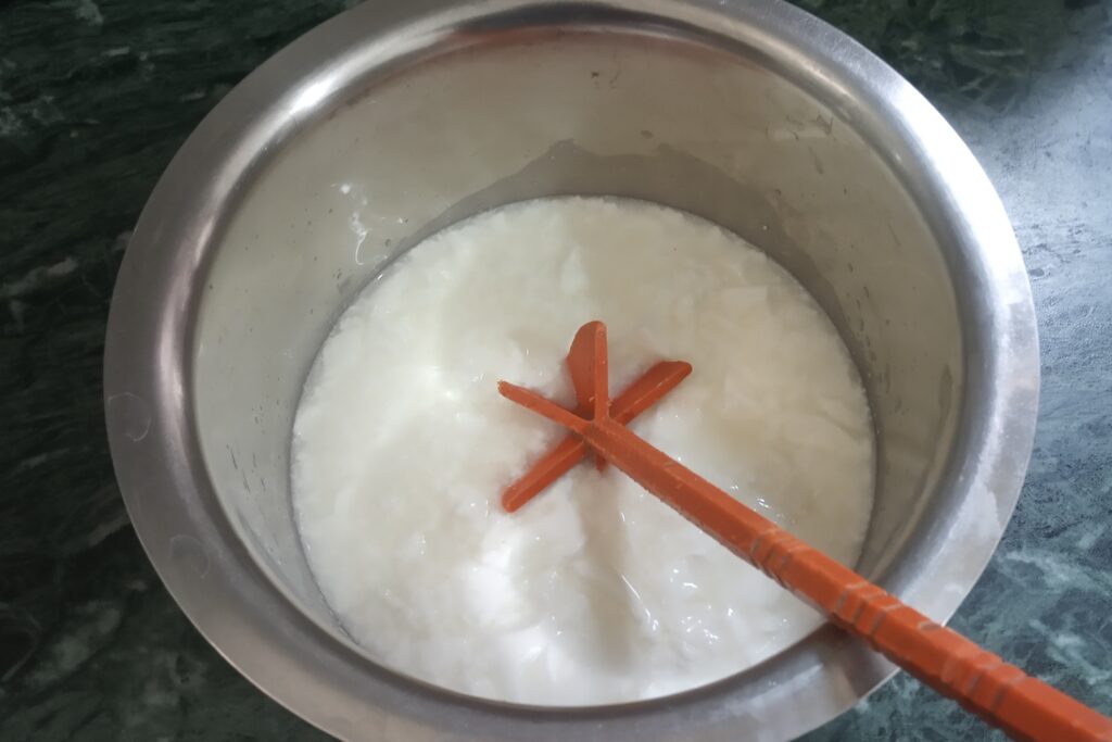whisking yogurt until smooth for raita