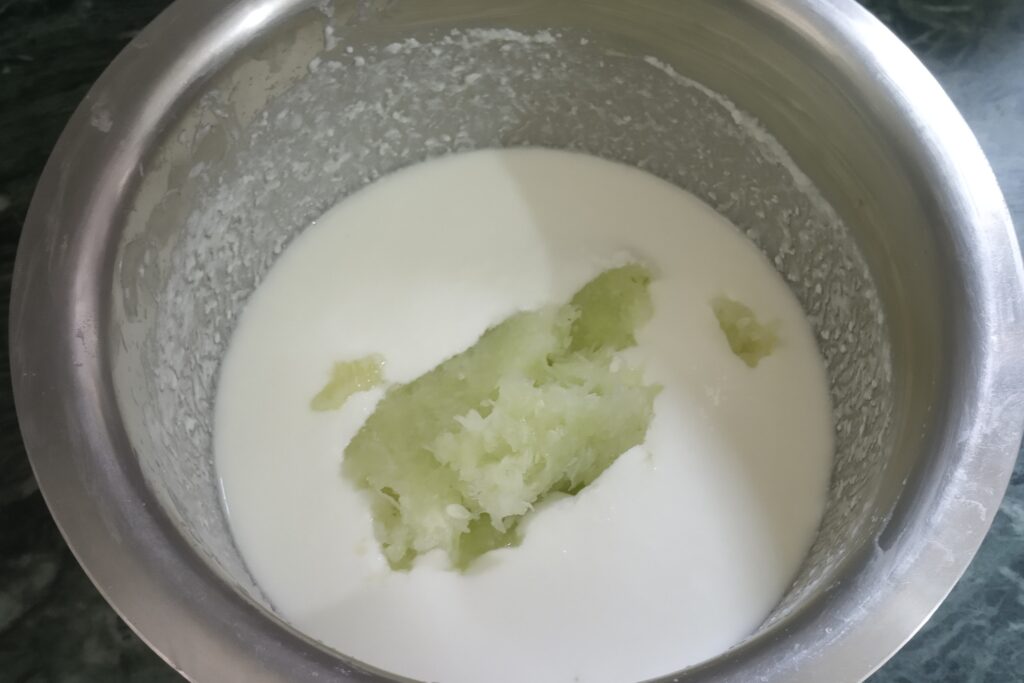 adding cucumber to the raita