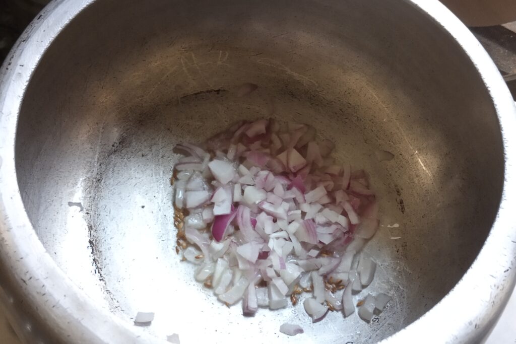adding chopped onion to saute