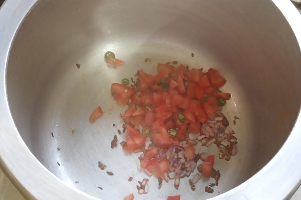 tomato and green chilli are sautieng