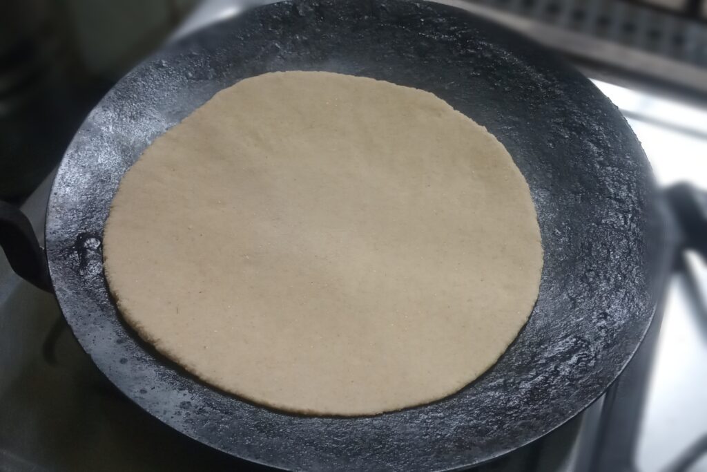 placed roti on the heated tawa