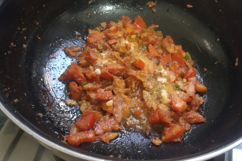 tempering spices with onion and tomatoes