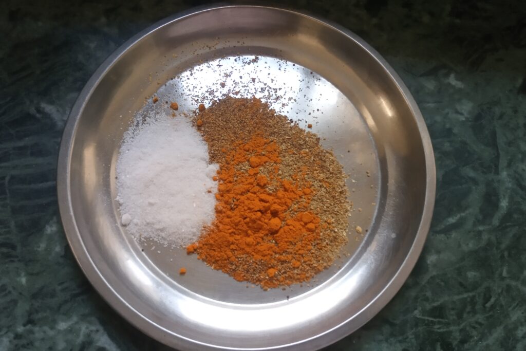 adding spices to a mixing bowl