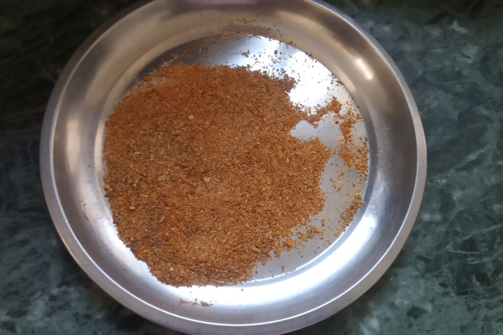 mixing spices for green chili pickle