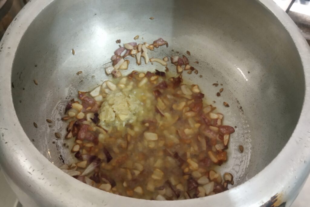 adding ginger and garlic paste to saute