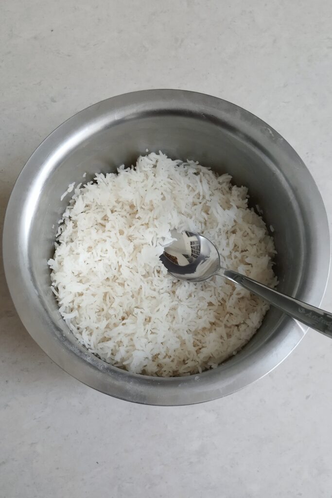 soft and fluffy rice in a pot with spoon