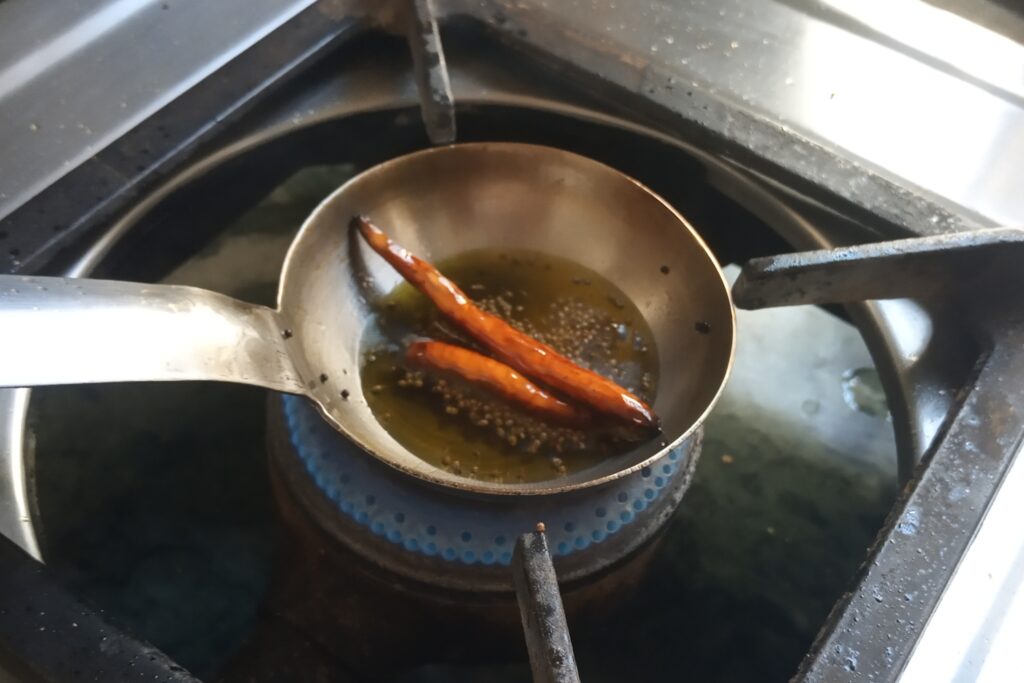 tempering mustard seeds ad red chilies