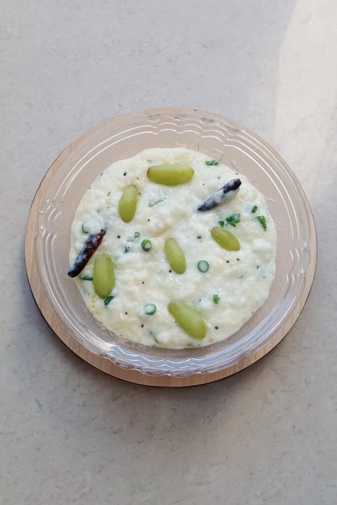 chilled curd rice served in a glass bowl
