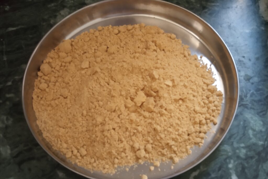 adding roasted sattu in a bowl