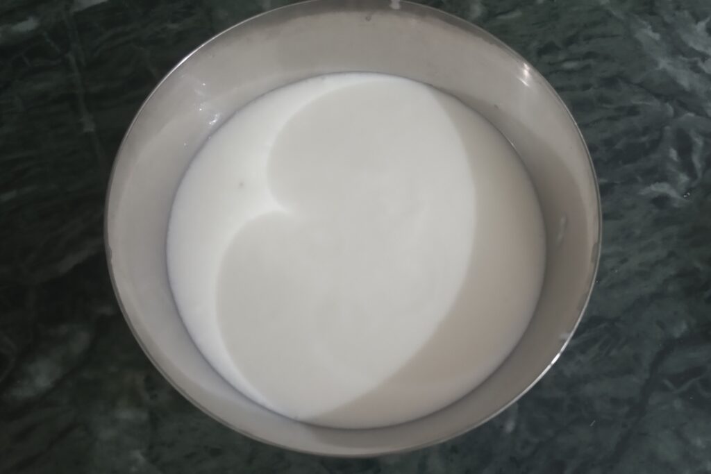 smooth curd in a bowl for potato raita