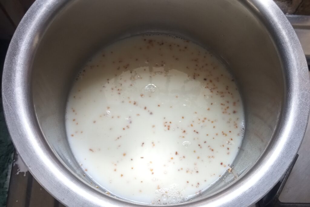 adding milk to the broken wheat