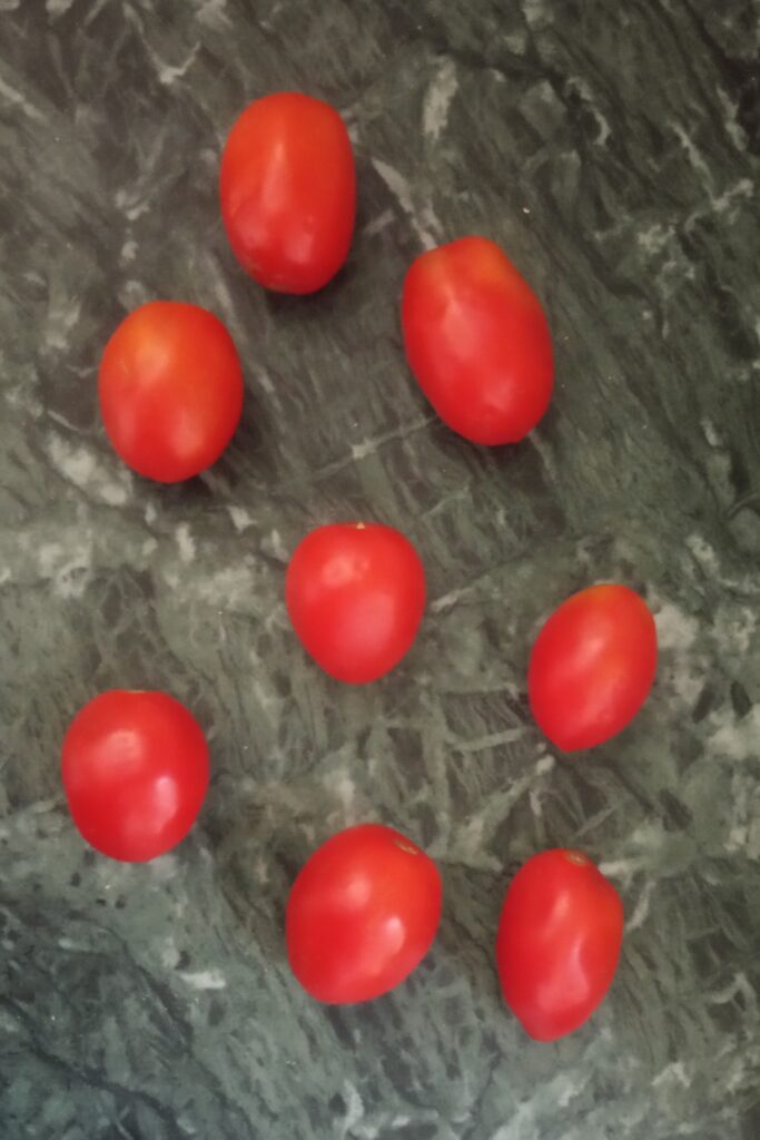the red raw tomatoes on green marble