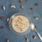 top shot of suji kheer recipe with a garnish of nuts