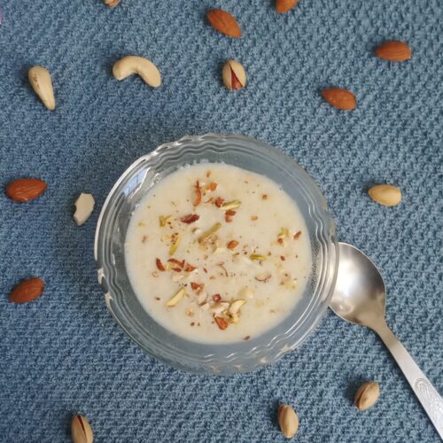top shot of suji kheer recipe with a garnish of nuts