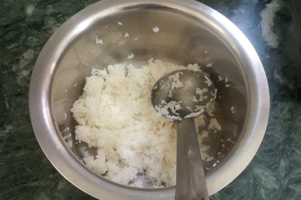 mashing cooked rice for pakoras
