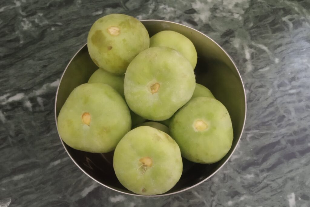 fresh and raw round gourds in a bowl
