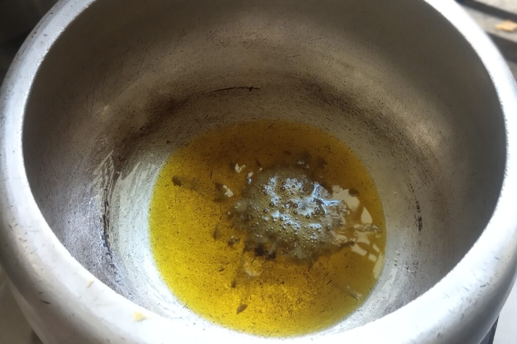 heating oil with cumin seeds for sabji