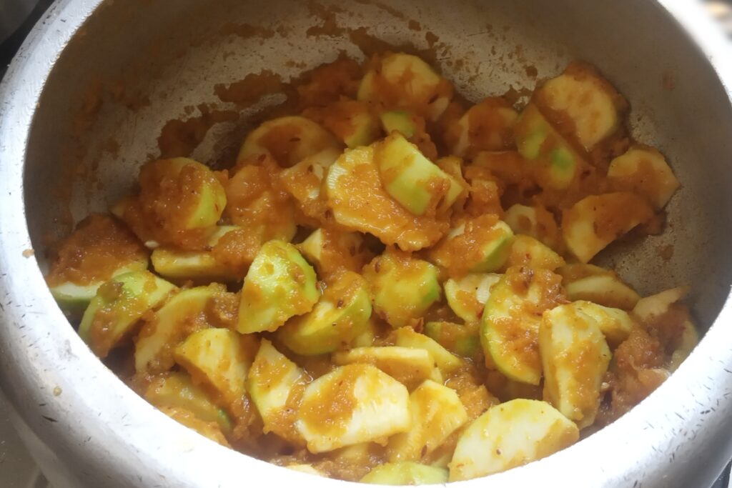 mixing round gourds with spices