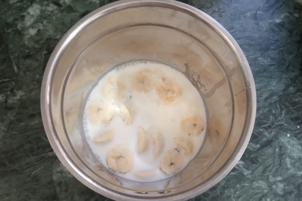 adding milk to a blender