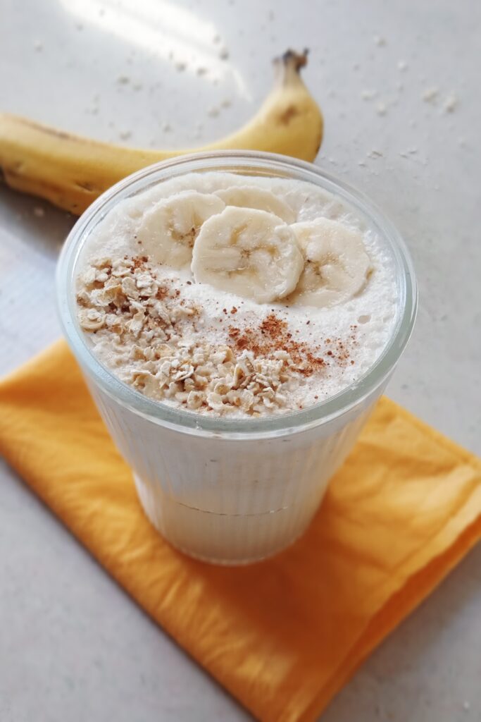 close up shot of oats banana smoothie recipe with the topping of oats