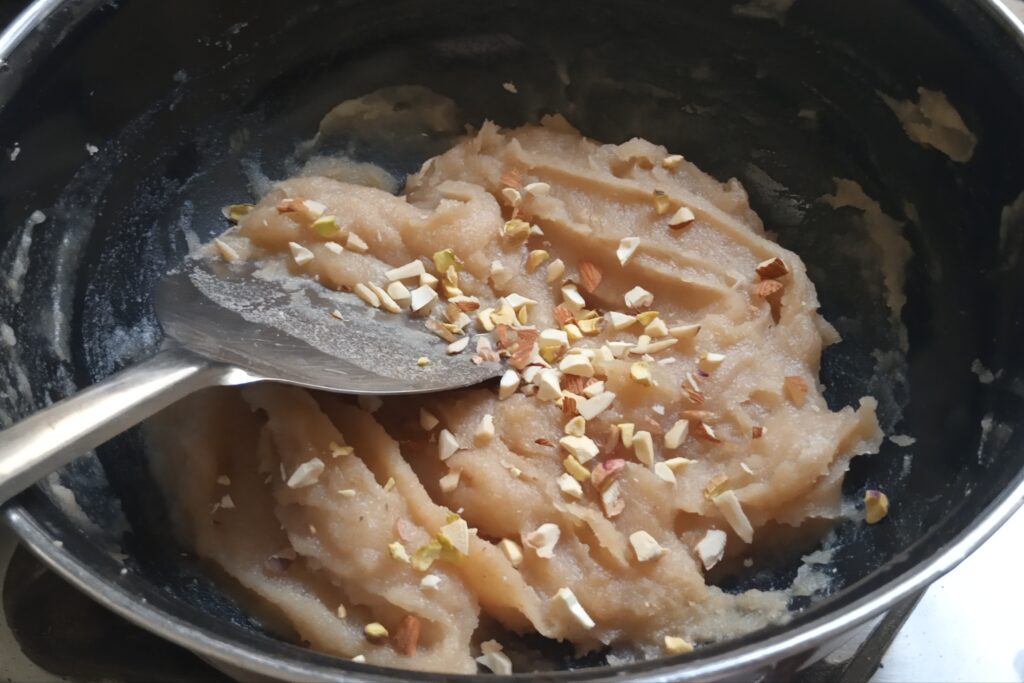adding chopped nuts to halwa