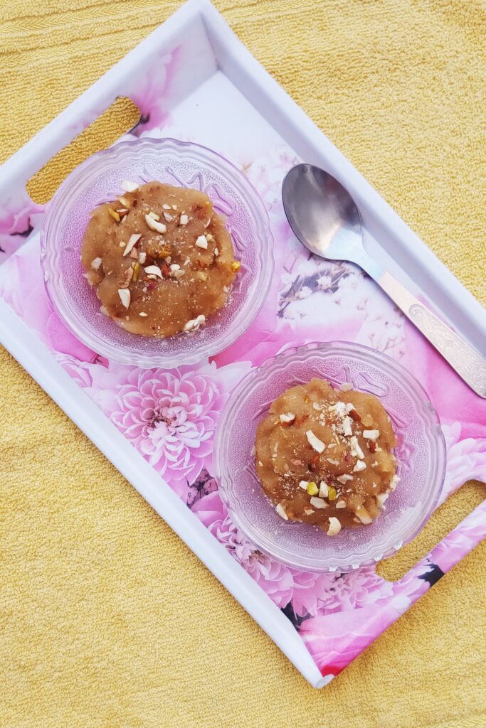 close shot of wheat halwa bowls garnished with chopped nuts