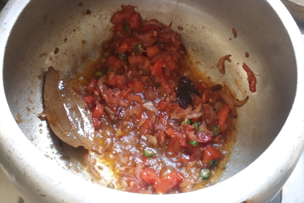 sauteing tomato and spices together