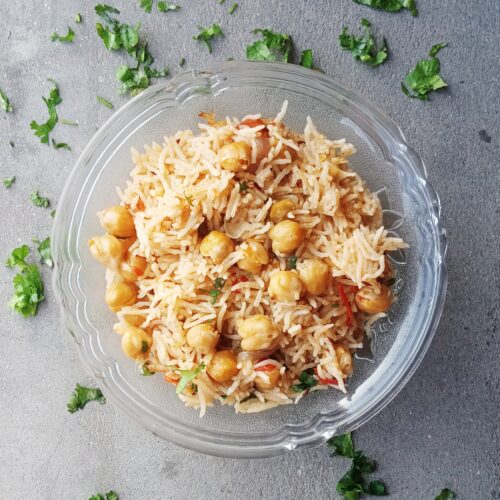 top shot of chole pulao served in a glass bowl