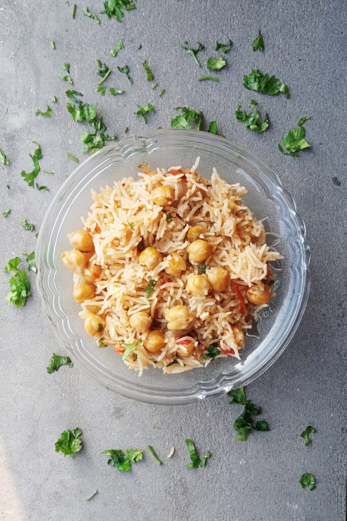 delicious chole pulao and some cilantro on grey tile