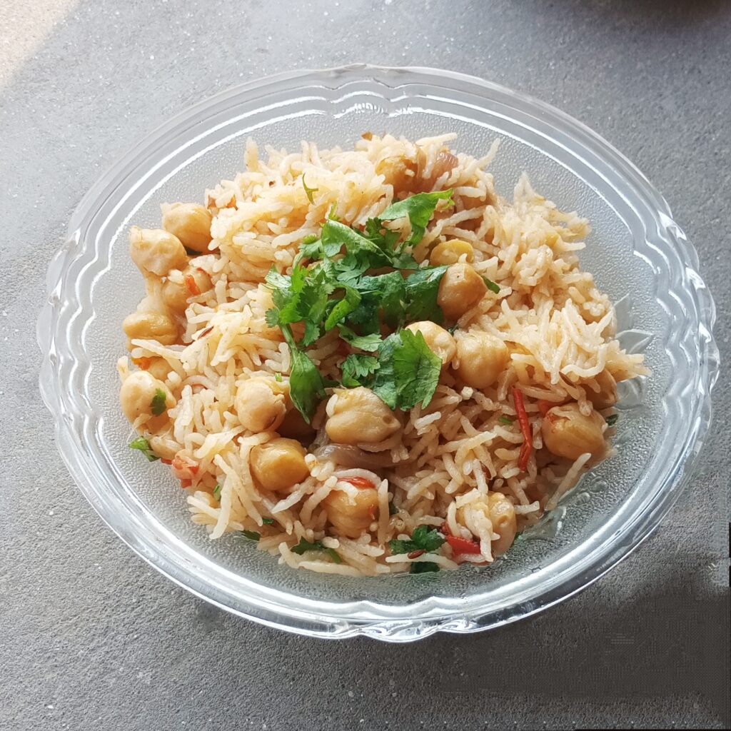 close up shot of chickpea pulao garnished with cilantro