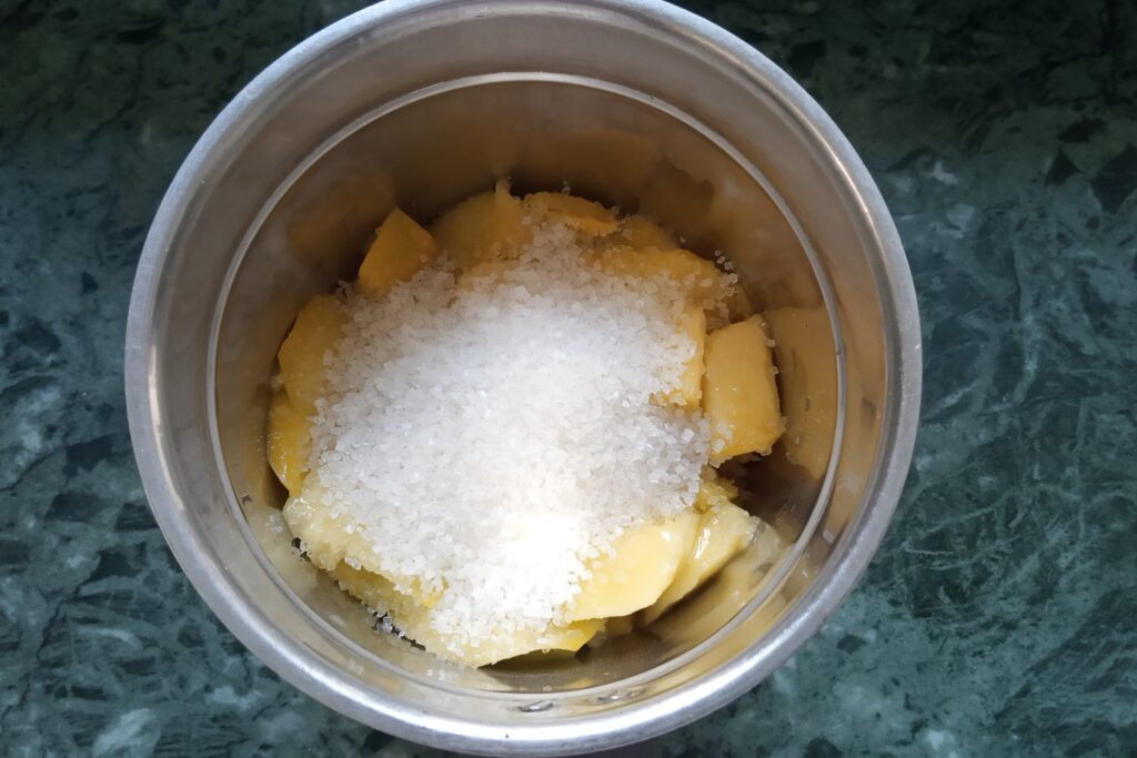 white refined sugar added in mango pieces